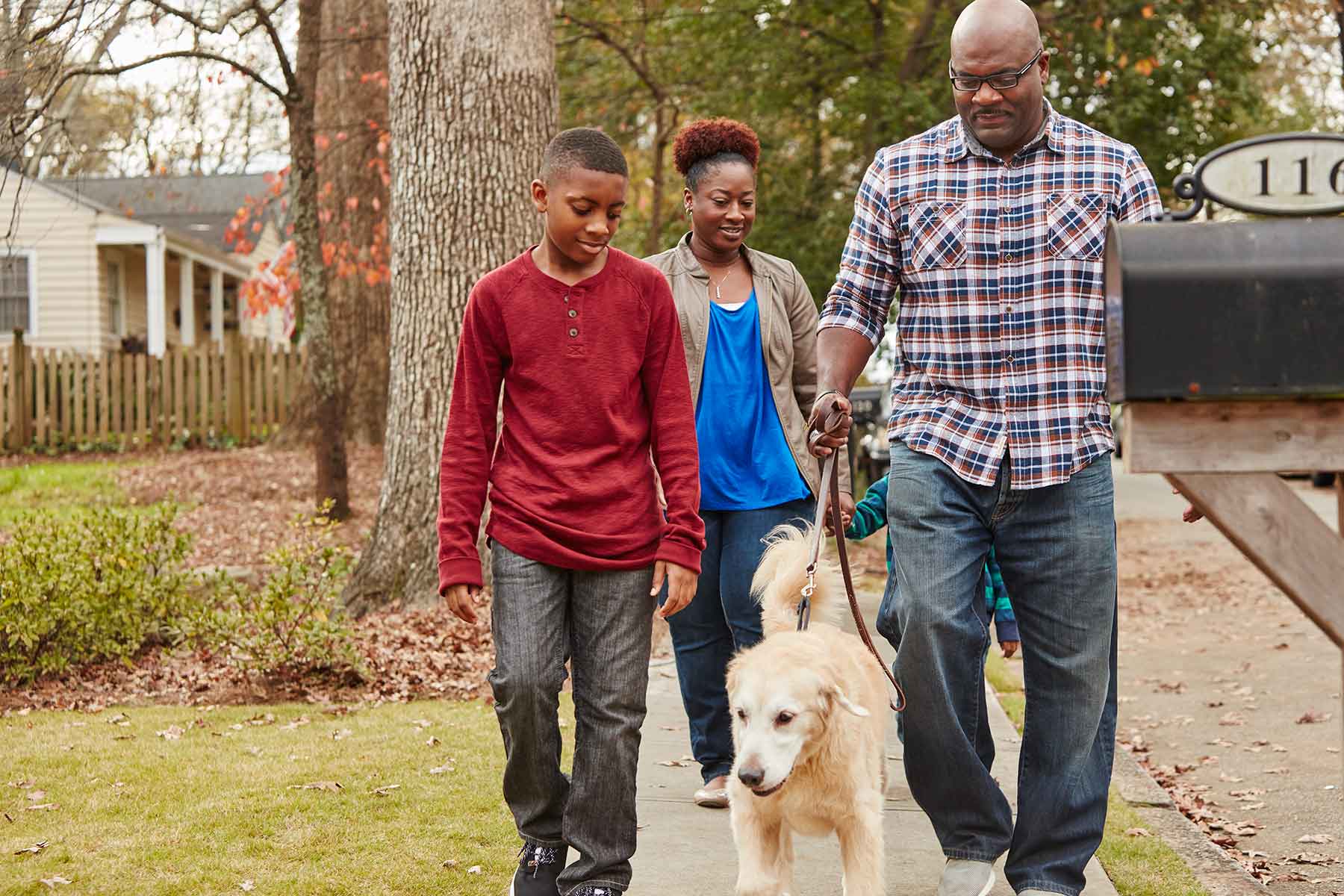 Family walking on sidewalk